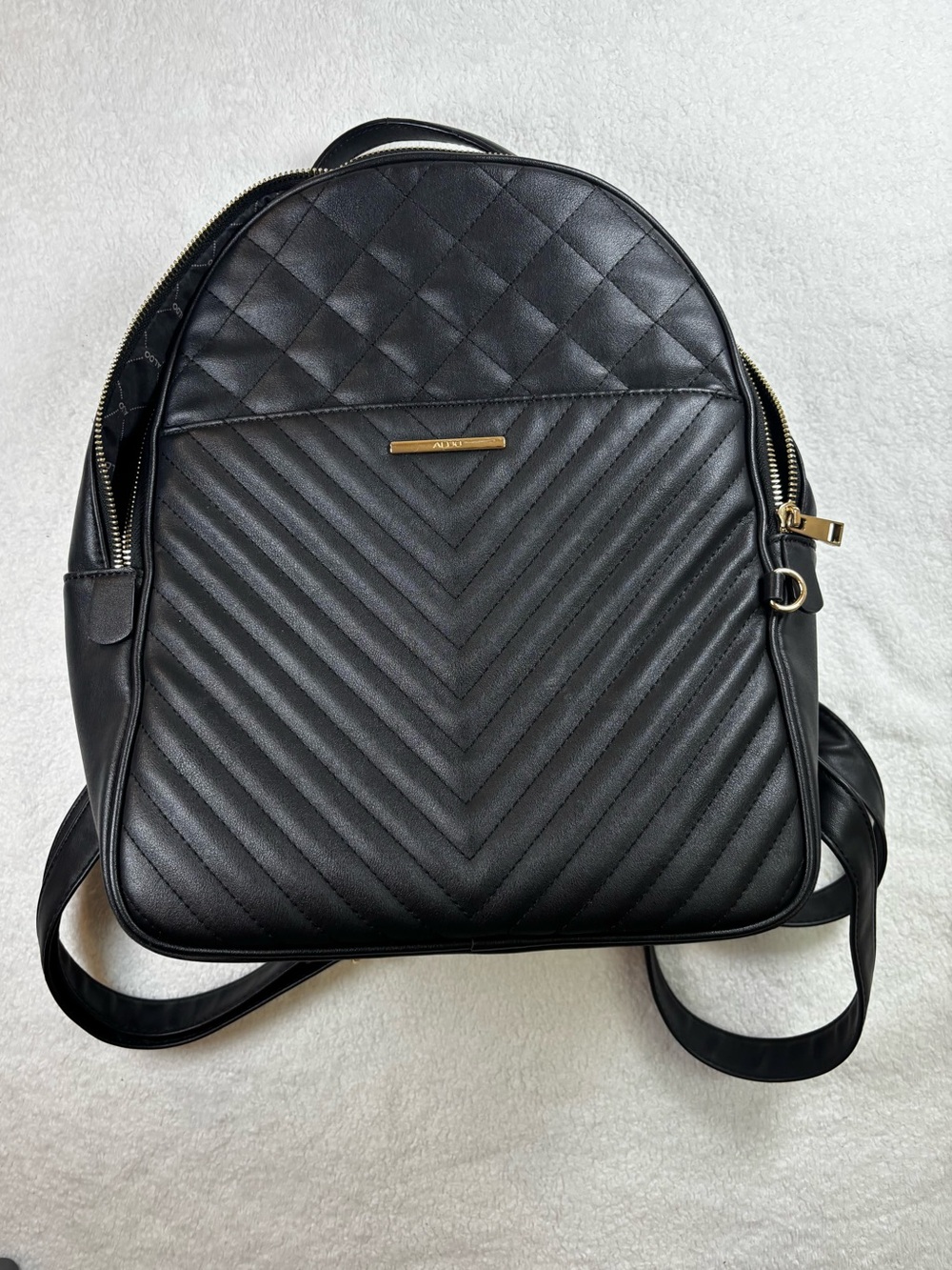 Black ALDO quilted backpack, chic faux leather, roomy everyday carry.